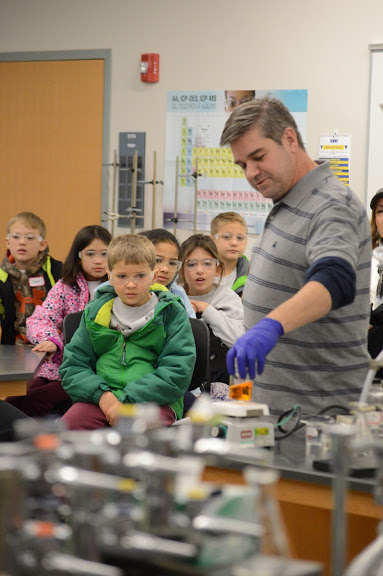 3rd graders watching a science experiment