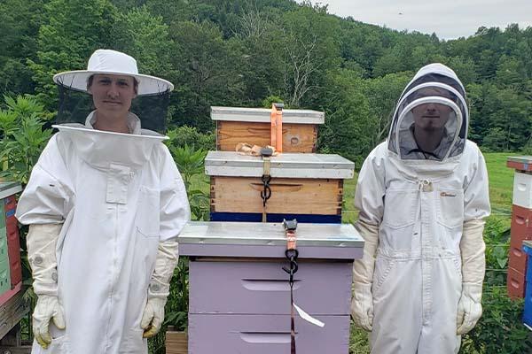 Two MCLA students in beekeeping gear