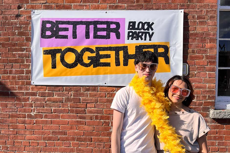MCLA "Better Together" block party two friends in front of a banner