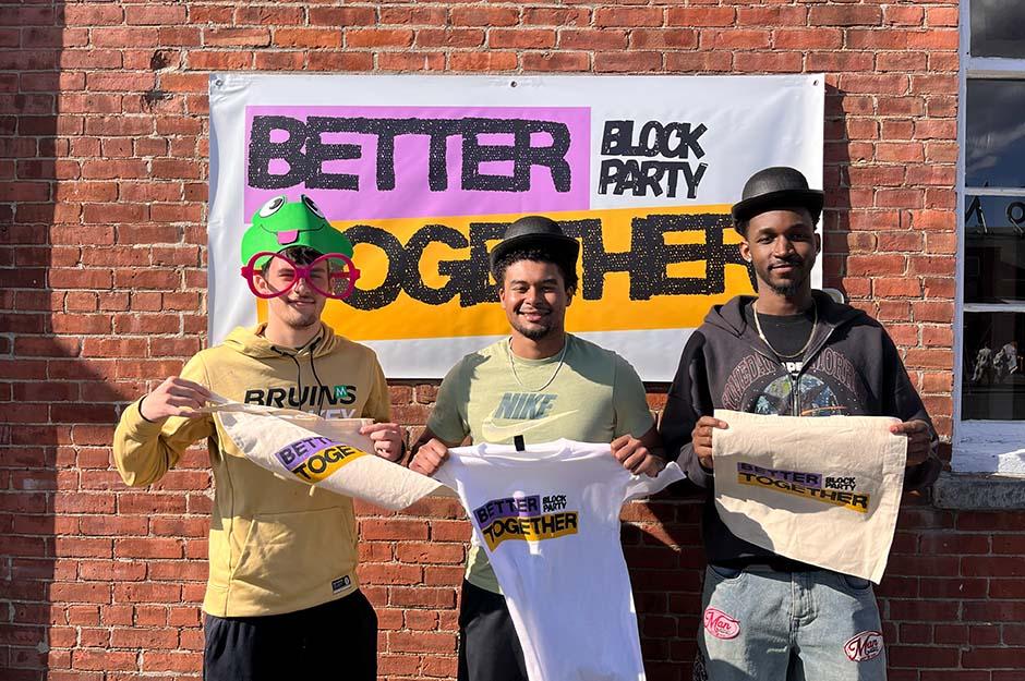 MCLA "Better Together" block party three friends in front of a banner