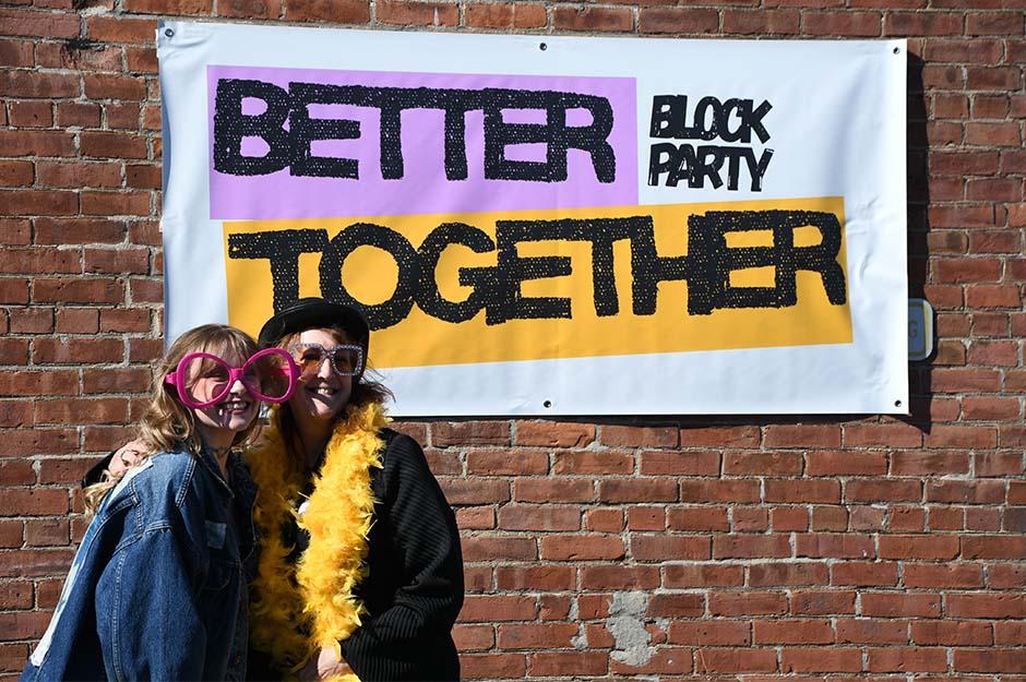 MCLA "Better Together" block party two friends with arms around each other
