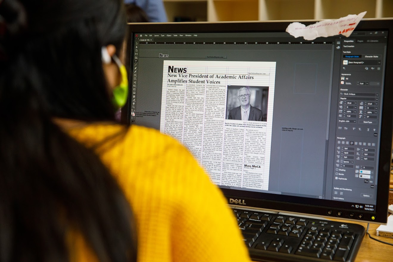 Student putting together The Beacon newspaper