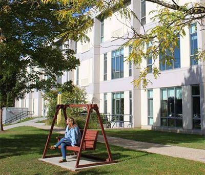student in swing outside