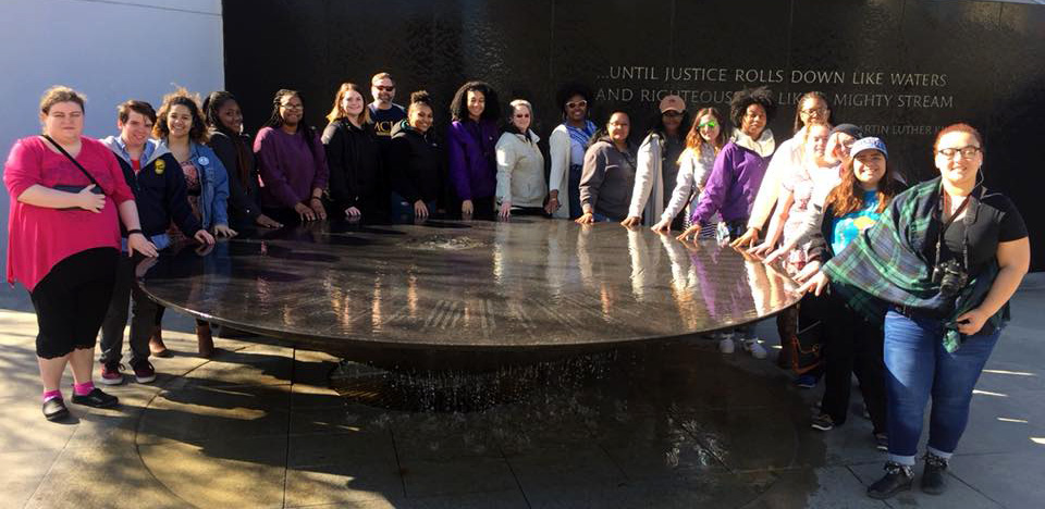 Students gathered around the reflecting pool at the Southern Poverty Law Center