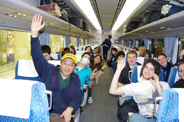 Dr. Huang riding with students in a speed train