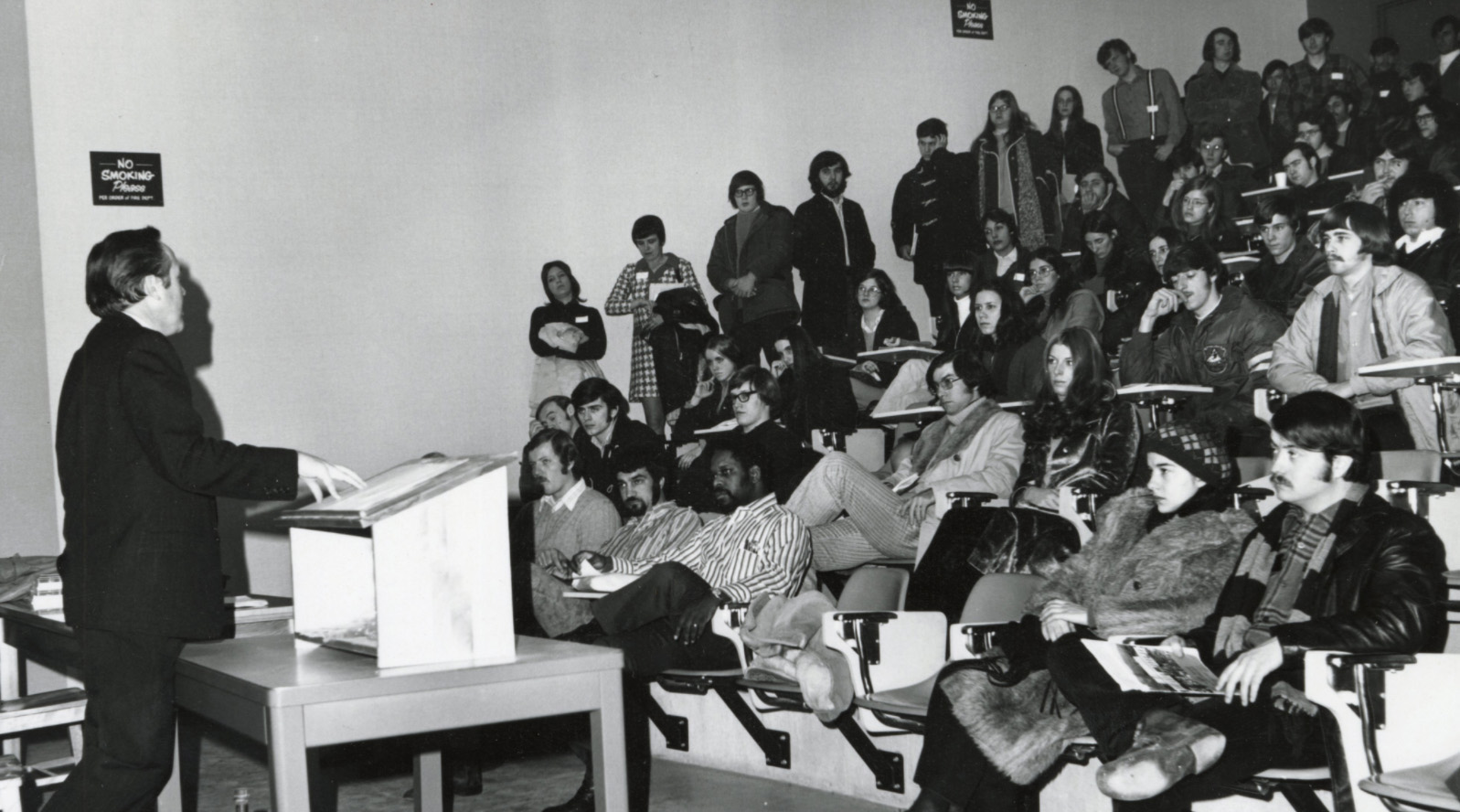 Professor lecturing to a crowded lecture hall