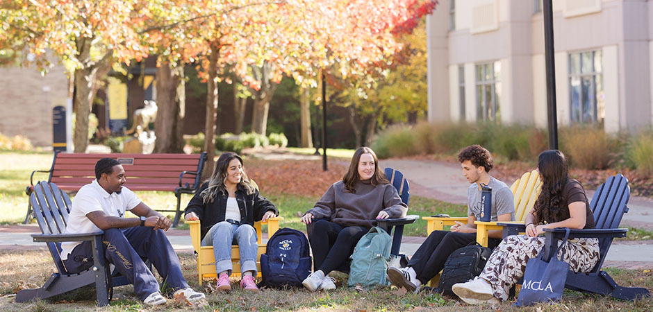 MCLA campus group of students sitting outdoors