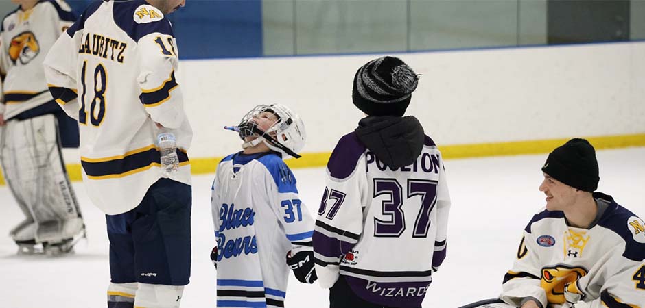 MCLA hockey players talking to local kids