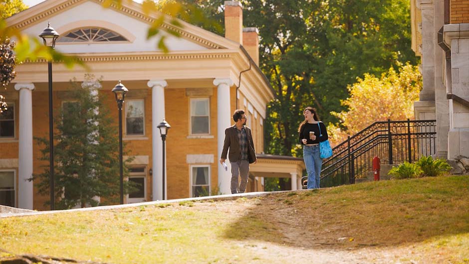 Students walking acrosss the MCLA campus with fall colors