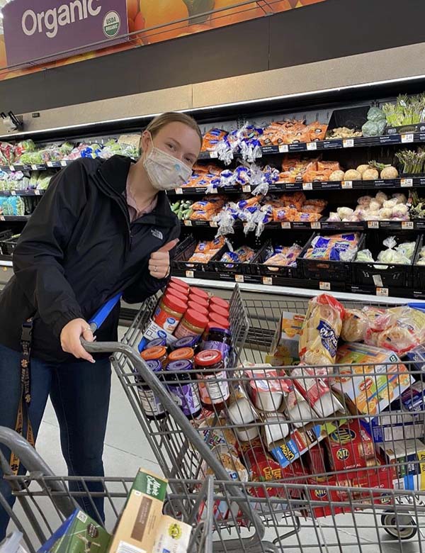 DeAnna Wardwell '22 with food items for the MCLA Food Pantry.