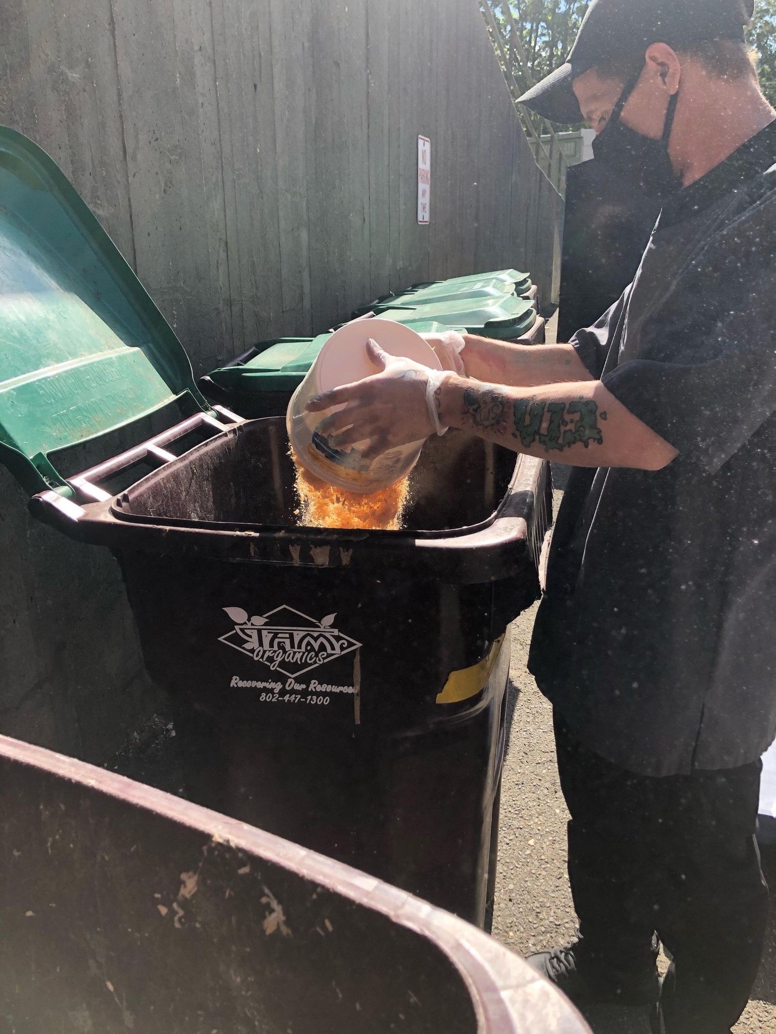 An MCLA Dining staff member sorts post-consumer waste for composting.