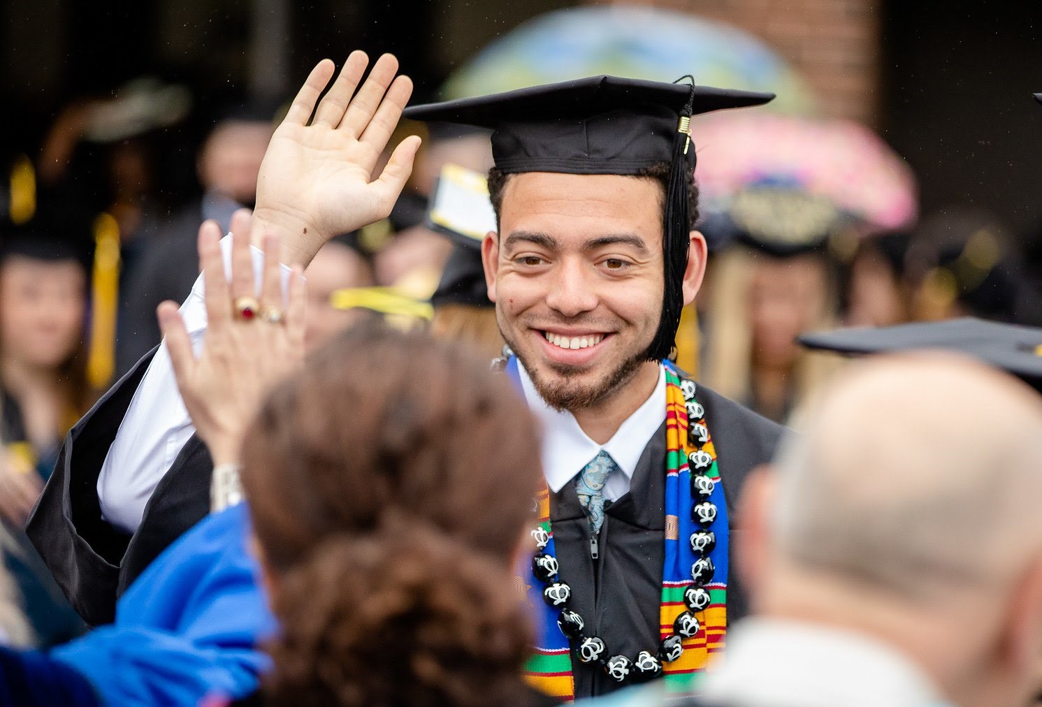 Student graduating giving a high five