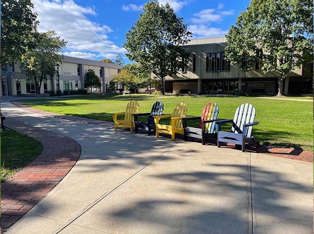 Empty Adirondack chairs on the MCLA campus.