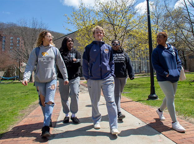 A group of MCLA students walking across campus.