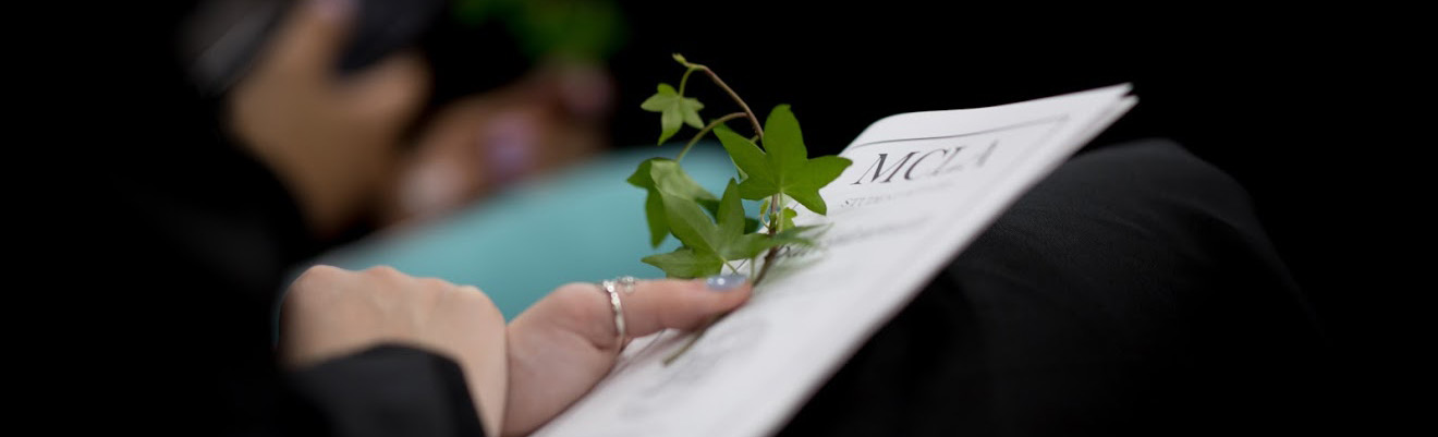 Parent holding ivy and program