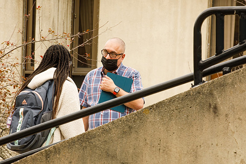 CDO, Dr. Christopher MacDonald-Dennis, listens to a student